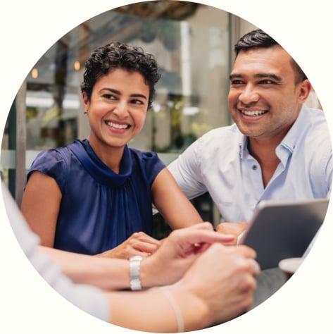 happy couple working with financial advisor on tablet